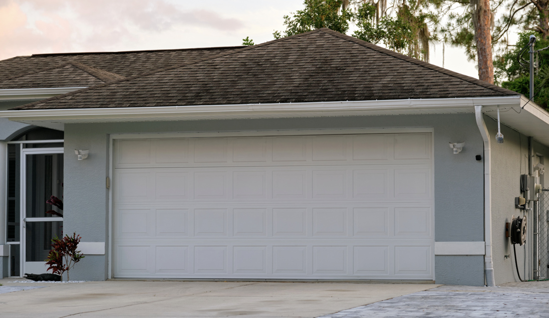 Double garage door with windows on brick Canadian home exterior