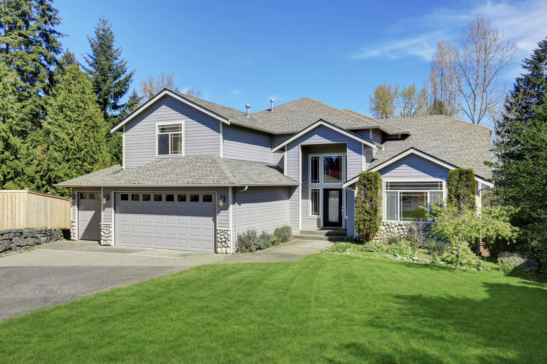 Residential modern garage door closed on driveway